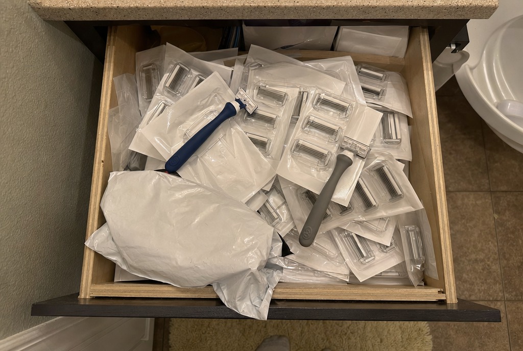 A bathroom drawer overflowing with unused plastic cartridge refills